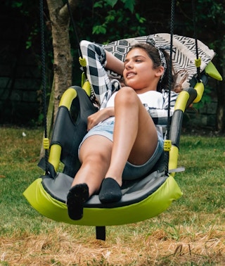 a girl in a gliding nest swing