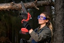 Lifestyle image of the UNTIMATY 6-inch Mini Chainsaw being used to cut a tree branch