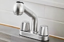 Lifestyle image of the stainless steel Glacier Bay Pull-Out Laundry Faucet (close up shot)
