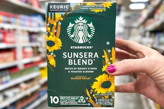 hand holding a box of starbucks kcups coffee