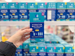 hand holding liquid i.v. hydration multiplier at target