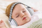 Baby sleeping with the Laudexua Noise Cancelling Headphones on.