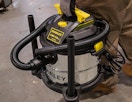 a person holding a wet/dry vacuum