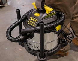 a person holding a wet/dry vacuum