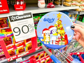 hand holding bluey christmas tin in walmart aisle