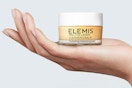 a woman holding the elemis balm