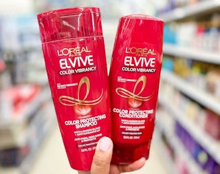 hand holding two bottles of L'Oreal Elvive hair care