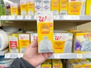 hand holding walgreens brand trash bags pack in store