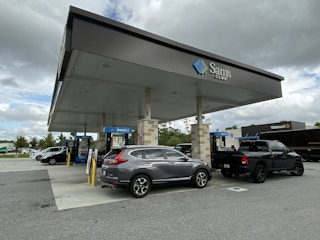 Vehicles parked at gas pumps at a Sam's Club gas station