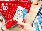 hand holding a cerave cleansing bar in front of a target