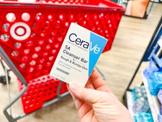 hand holding a cerave cleansing bar in front of a target