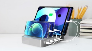 a silver charging station with tablets and smart phones plugged into it