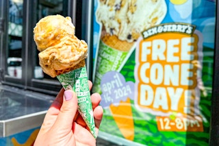 someone holding up a cone outside of Ben and Jerry's on free cone day