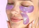 a person with purple eye patches on their face