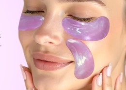 a person with purple eye patches on their face