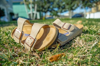 two Birkenstock sandals on the ground.
