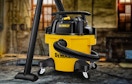 a yellow and black wet vacuum in a basement