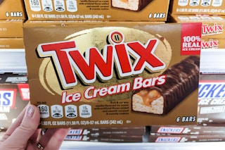hand holding a box of twix ice cream bars at kroger
