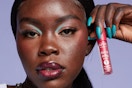 a woman holding nyx gloss