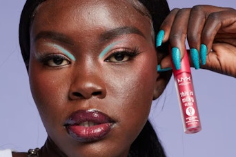 a woman holding nyx gloss