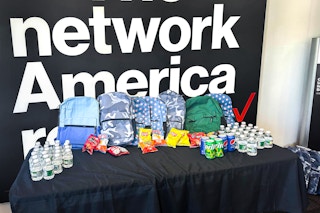 verizon backpacks lined up on a table inside of a verizon store