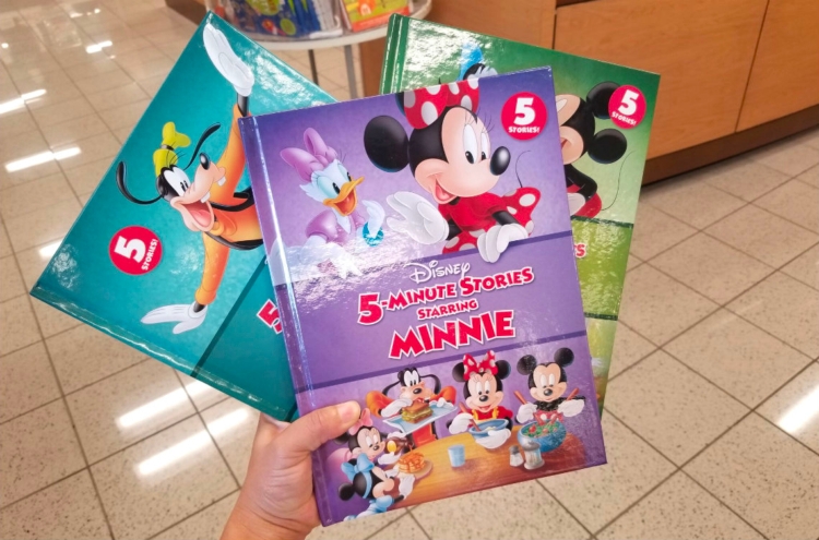 Hand holding Disney 5 minute stories books in a Kohl's store