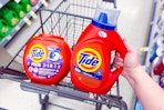 person placing tide detergent in a cart