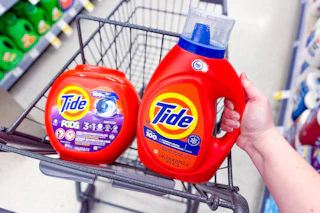 tide pods and liquid detergent in a walgreens cart