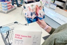 person holding an 8x10 photo print in a store