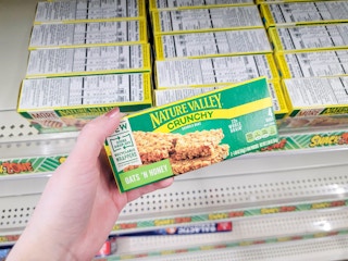 Hand holding a box of Nature Valley granola bars
