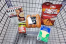 pretzel bites, salsa, brioche hot dog buns, provolone cheese slices, and chips in a cart