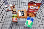 pretzel bites, salsa, brioche hot dog buns, provolone cheese slices, and chips in a cart