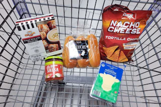 pretzel bites, salsa, brioche hot dog buns, provolone cheese slices, and chips in a cart