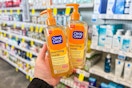 person holding 2 bottles of clean and clear face wash