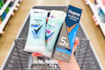 Hand holding Degree deodorants over a shopping cart