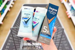 Hand holding Degree deodorants over a shopping cart
