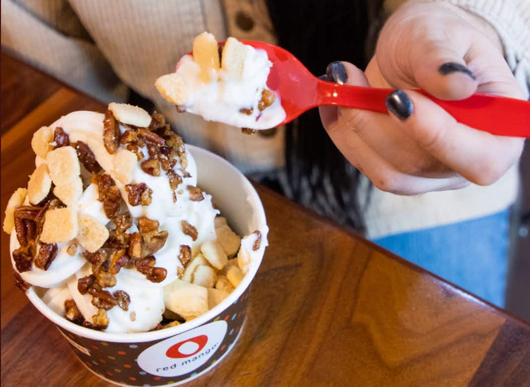 A cup of froyo from Red Mango, who has a fill-a-cup deal on national frozen yogurt day.