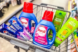 crest toothpaste, persil detergent, garnier shampoo, and sally hansen nail polish in a cart