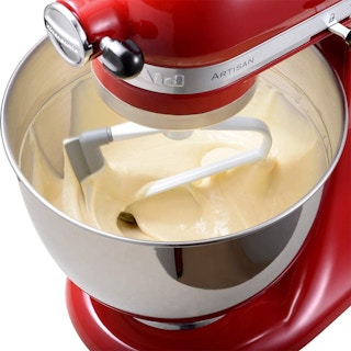 A KitchenAid mixer mixing batter.