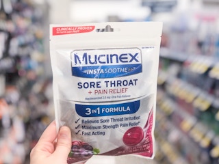 hand holding mucinex cough throat drops walgreens store 1692815707 1692815707