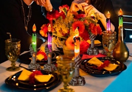 Halloween LED skeleton candles on a table with decorations