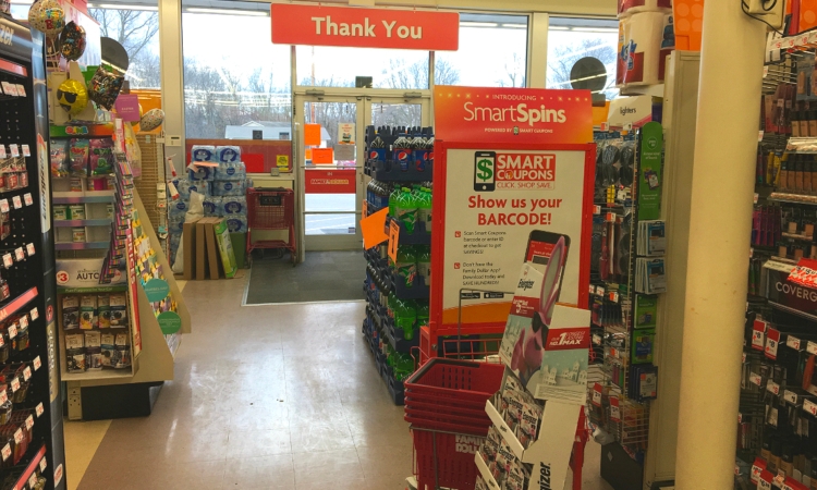 Inside of Family Dollar, with product displays and Smart Coupons poster