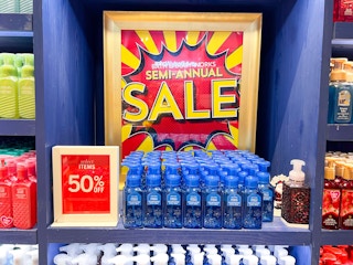 hand soaps on shelf in front of bath and body works semi annual sale sign
