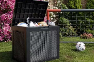 image of a deck storage box with sports equipment in it by a soccer net