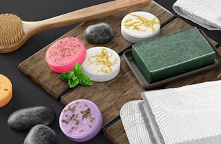 colorful shower steamers on a table with soap and a shower brush