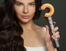a person holding a hair dryer