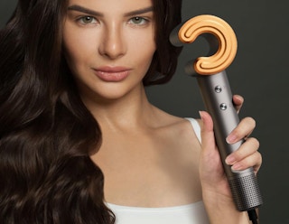 a person holding a hair dryer