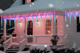  Minetom Icicle Lights Outdoor with Clips on a house during the winter with snow.