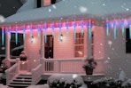 Minetom Icicle Lights Outdoor with Clips on a house during the winter with snow.