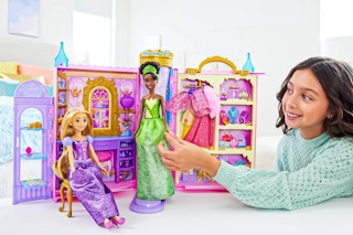 Lifestyle image of girl playing with the Disney Princess Ready for the Ball Closet Playset